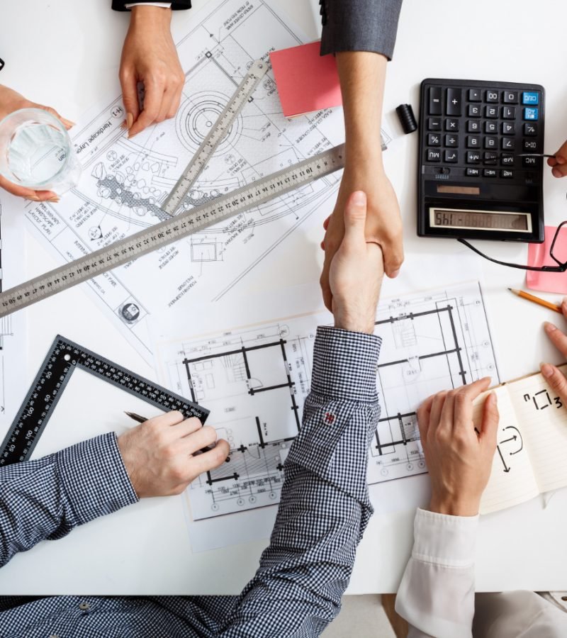 businessmen-hands-white-table-with-documents-drafts